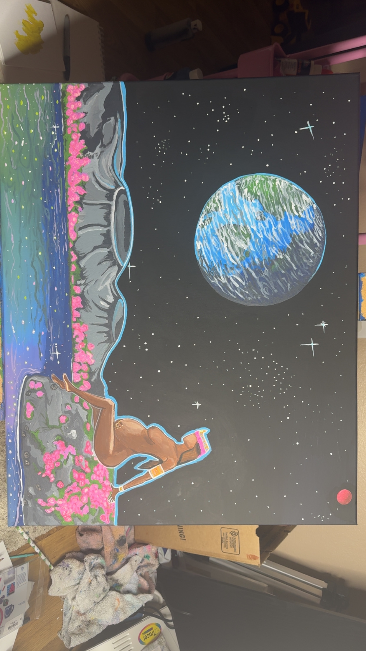 Person sitting on a bench with pink flowers, gazing at Earth from space with stars and a starry sky background.