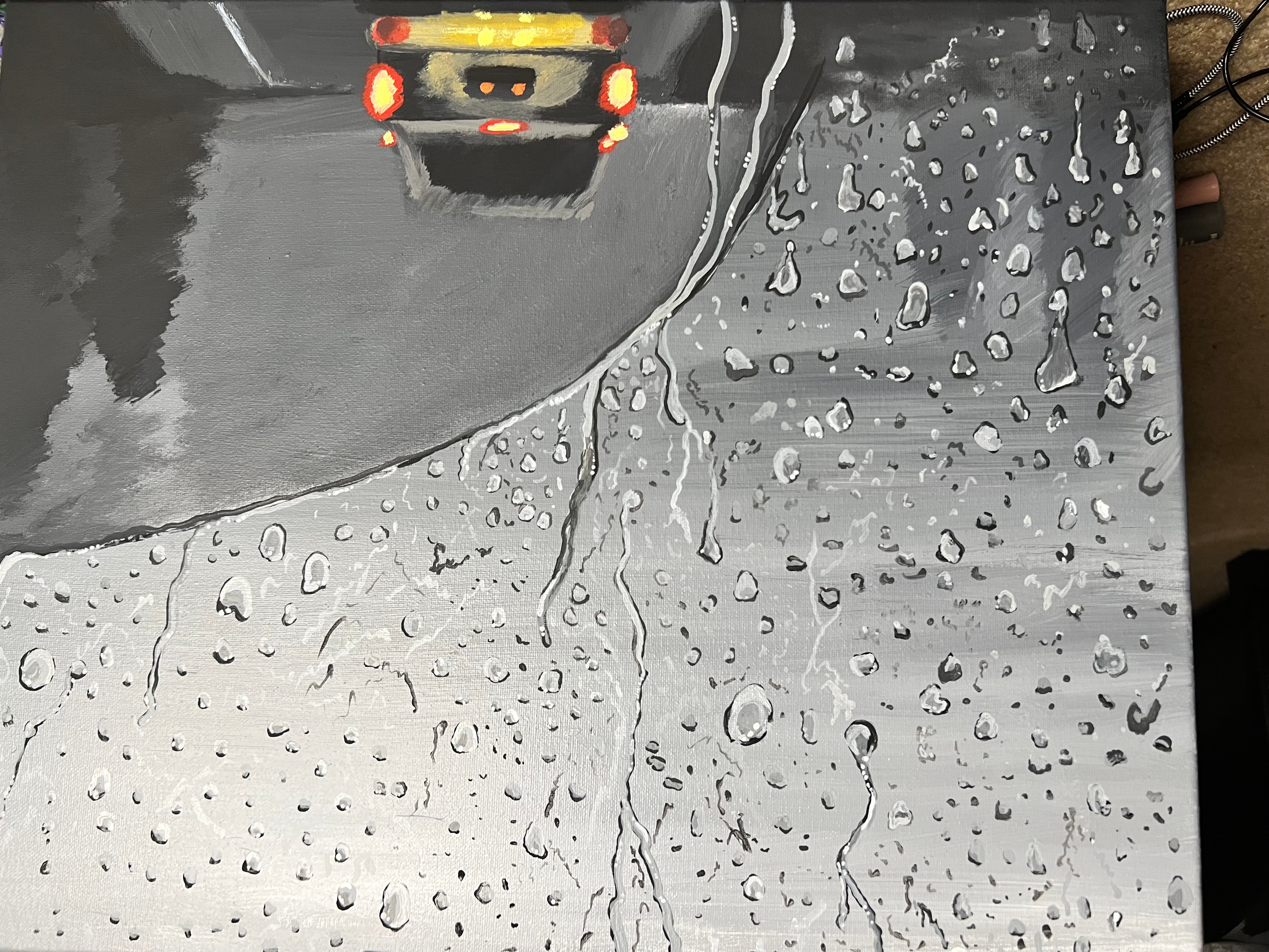 Rainy scene with a car on wet road, water droplets on window, and reflections on the surface.
