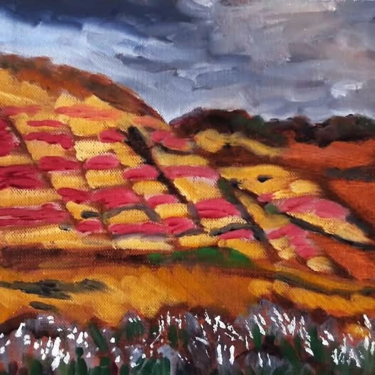 Landscape painting of a hillside with colorful patches, under a cloudy sky, with dark foreground and vibrant colors.