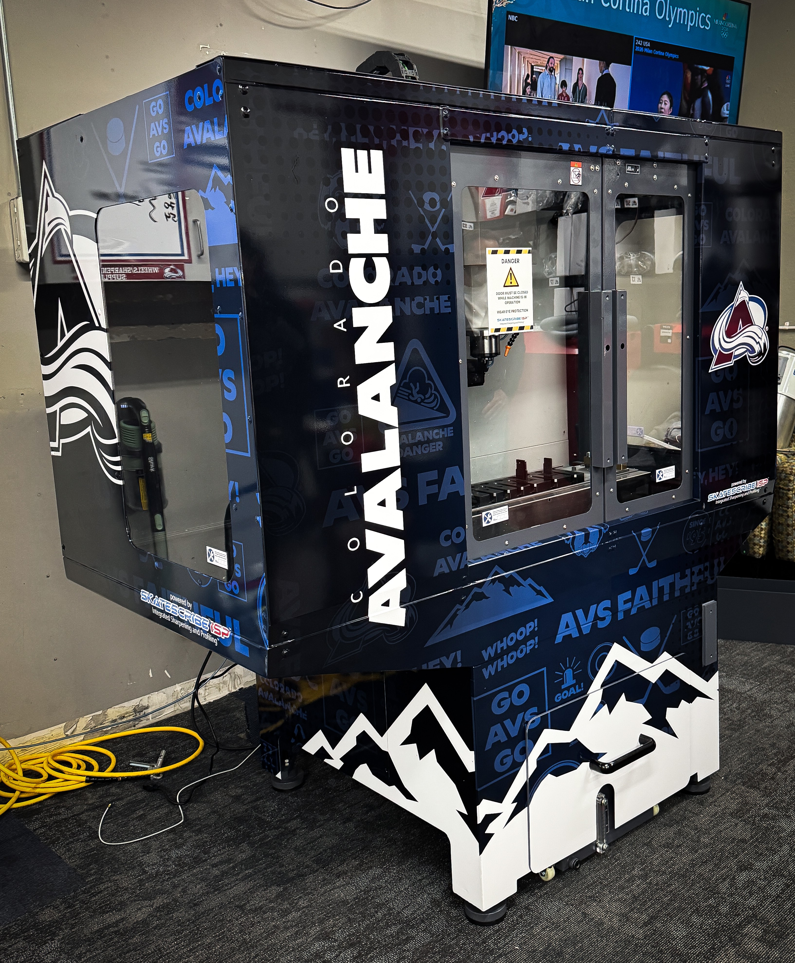 A black and white Avalanche-themed arcade or gaming machine with glass doors, mountain graphics, and the word 'Avalanche' on the side.