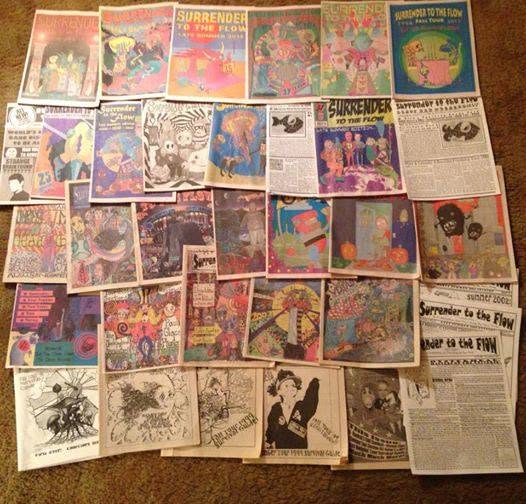 Collection of comic books and magazines spread on the floor, featuring colorful covers and illustrations.
