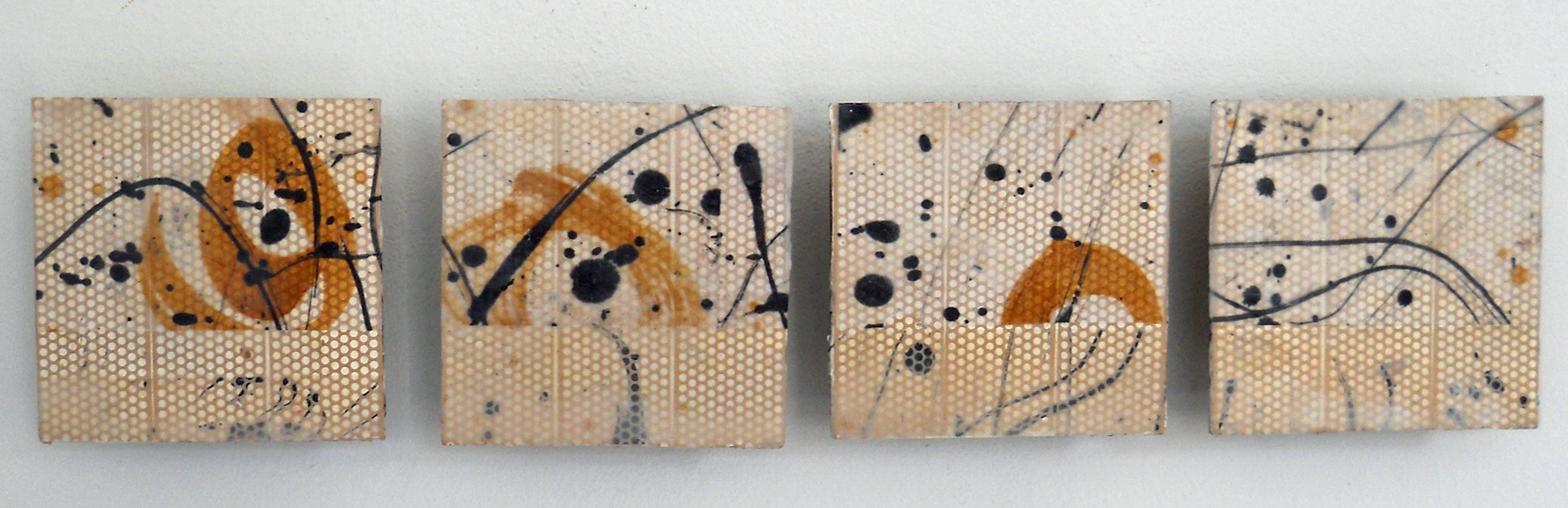 Four abstract paintings with orange, black, and beige colors, featuring dots and curved lines, arranged in a row.