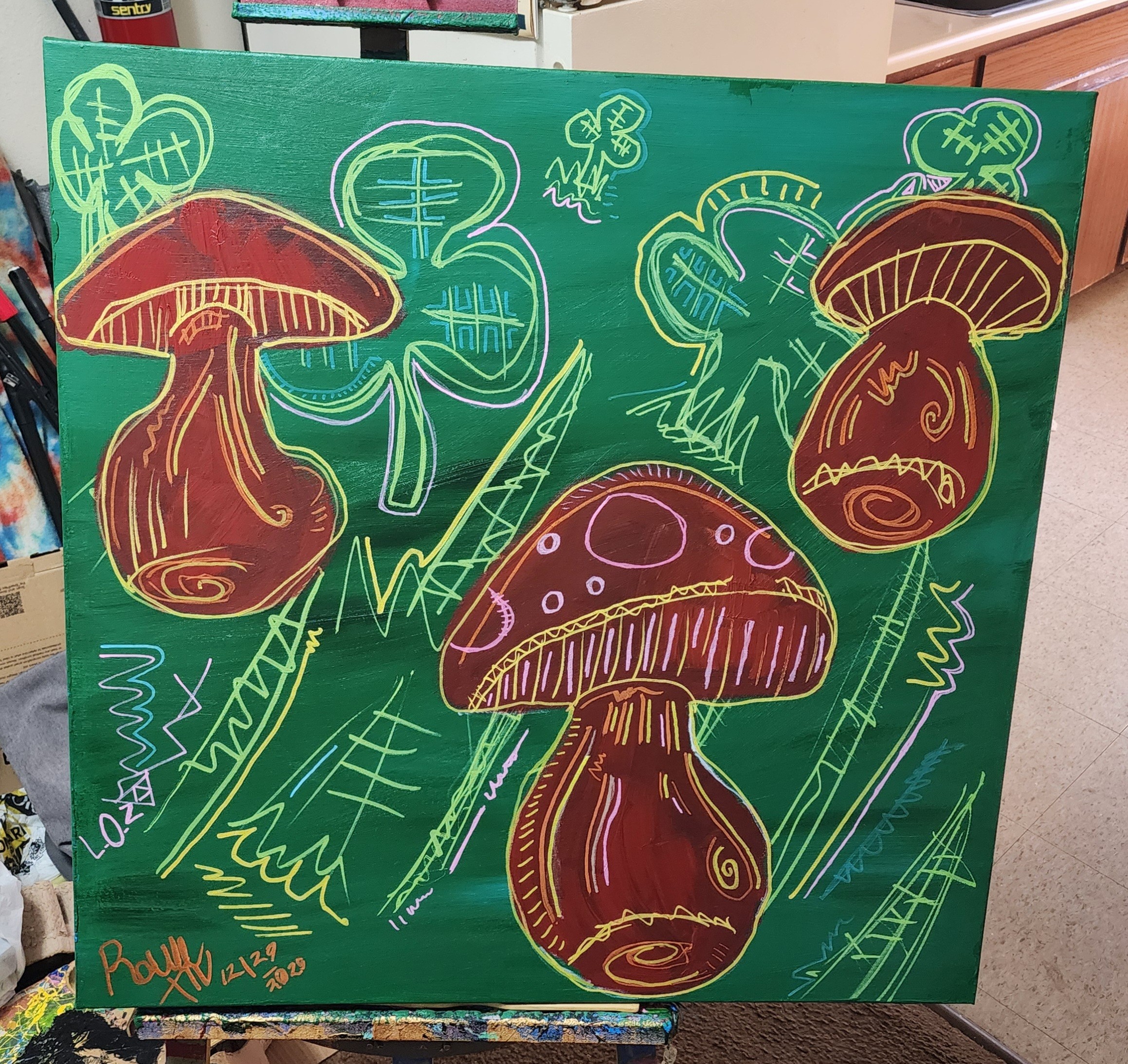 Colorful drawing of three mushrooms on a green background with abstract shapes and lines.