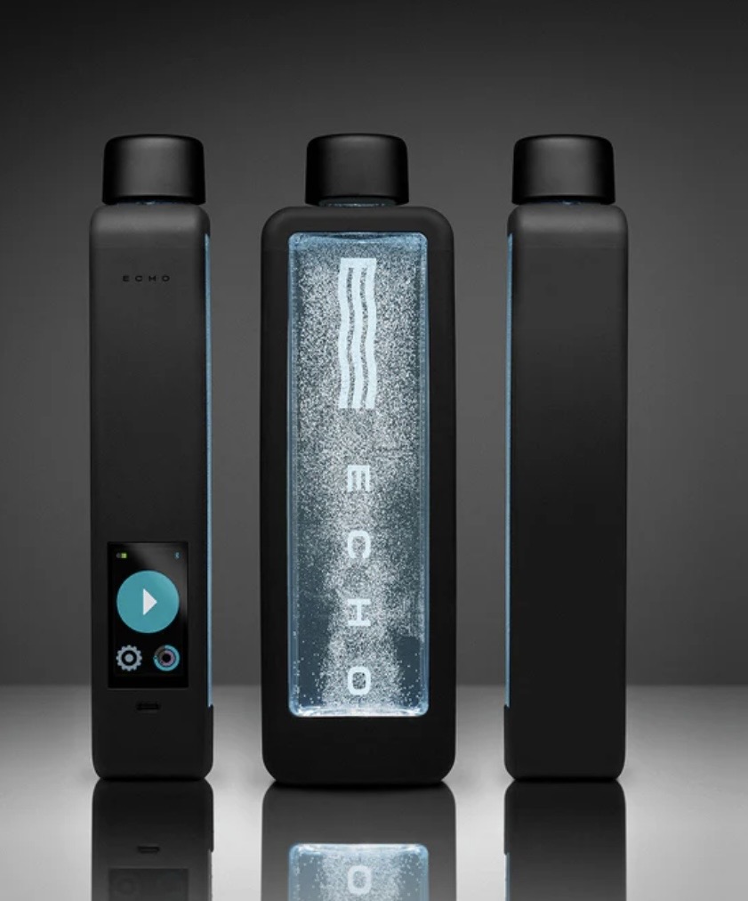 Three black electronic devices with one displaying a blue screen and water splash, set against a dark background.