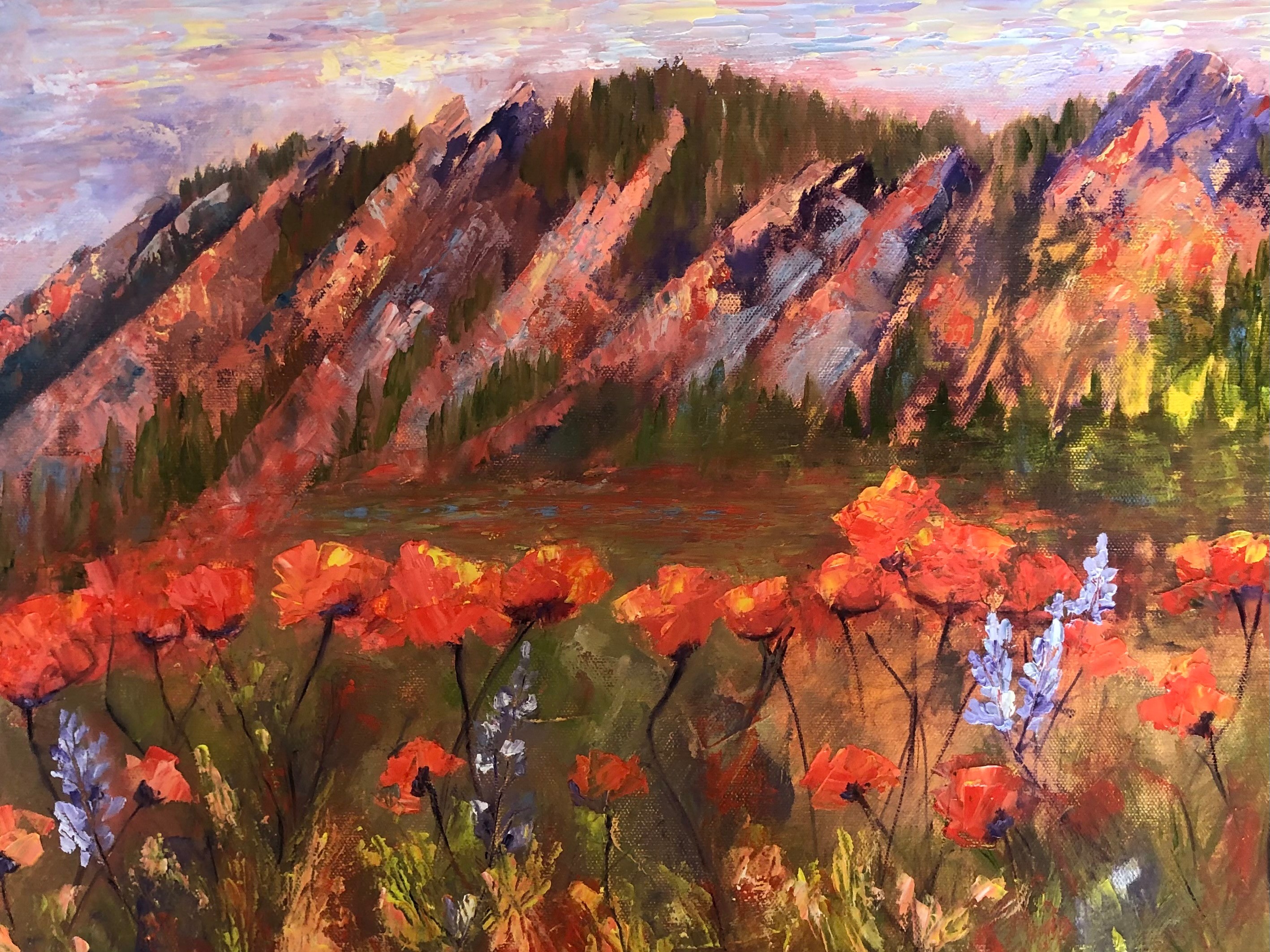 Landscape with colorful mountains in the background and orange flowers in the foreground, painted in an impressionistic style.