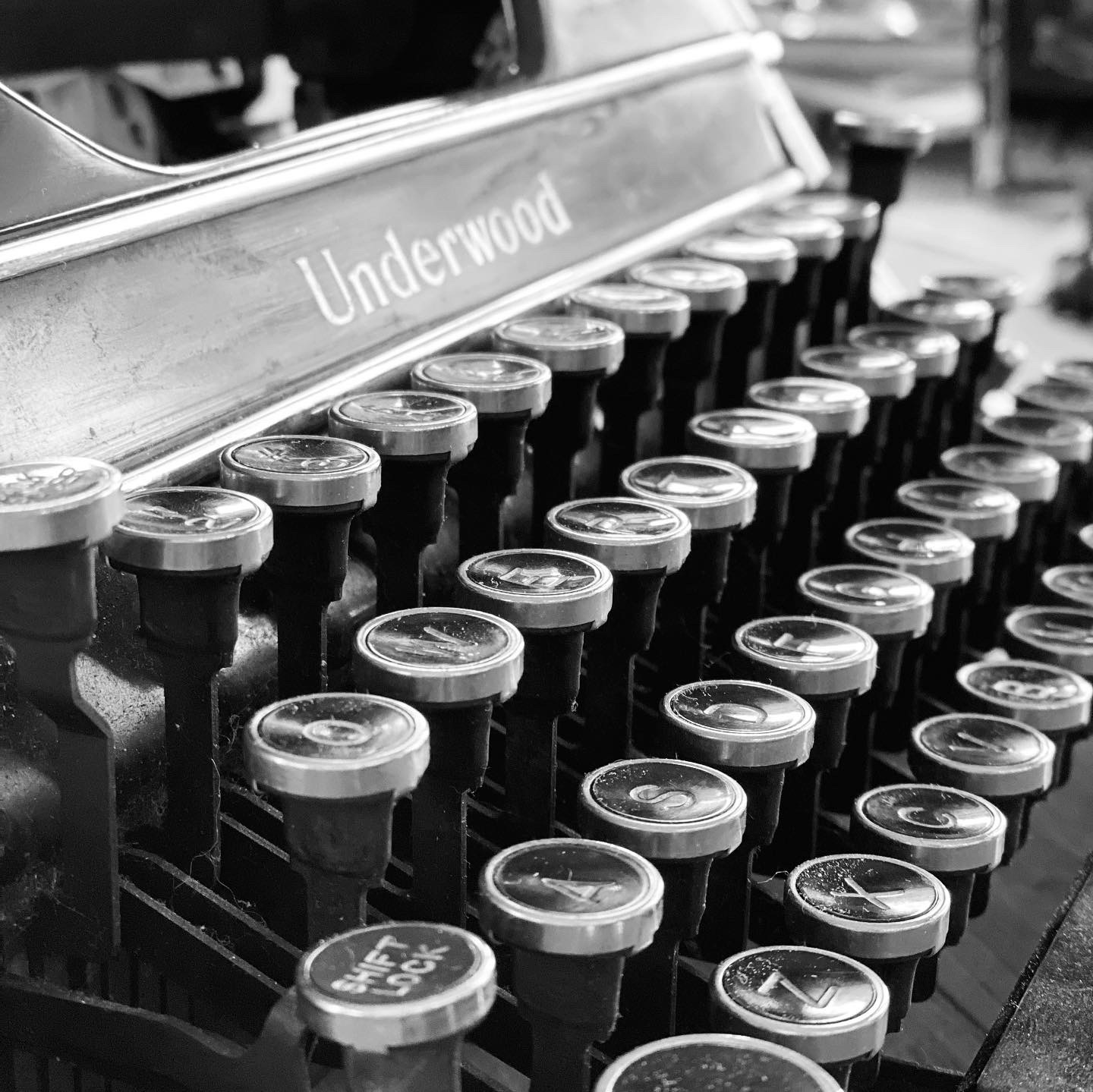 Close-up of vintage Underwood typewriter keys arranged in rows, with the brand name visible on the metal frame.