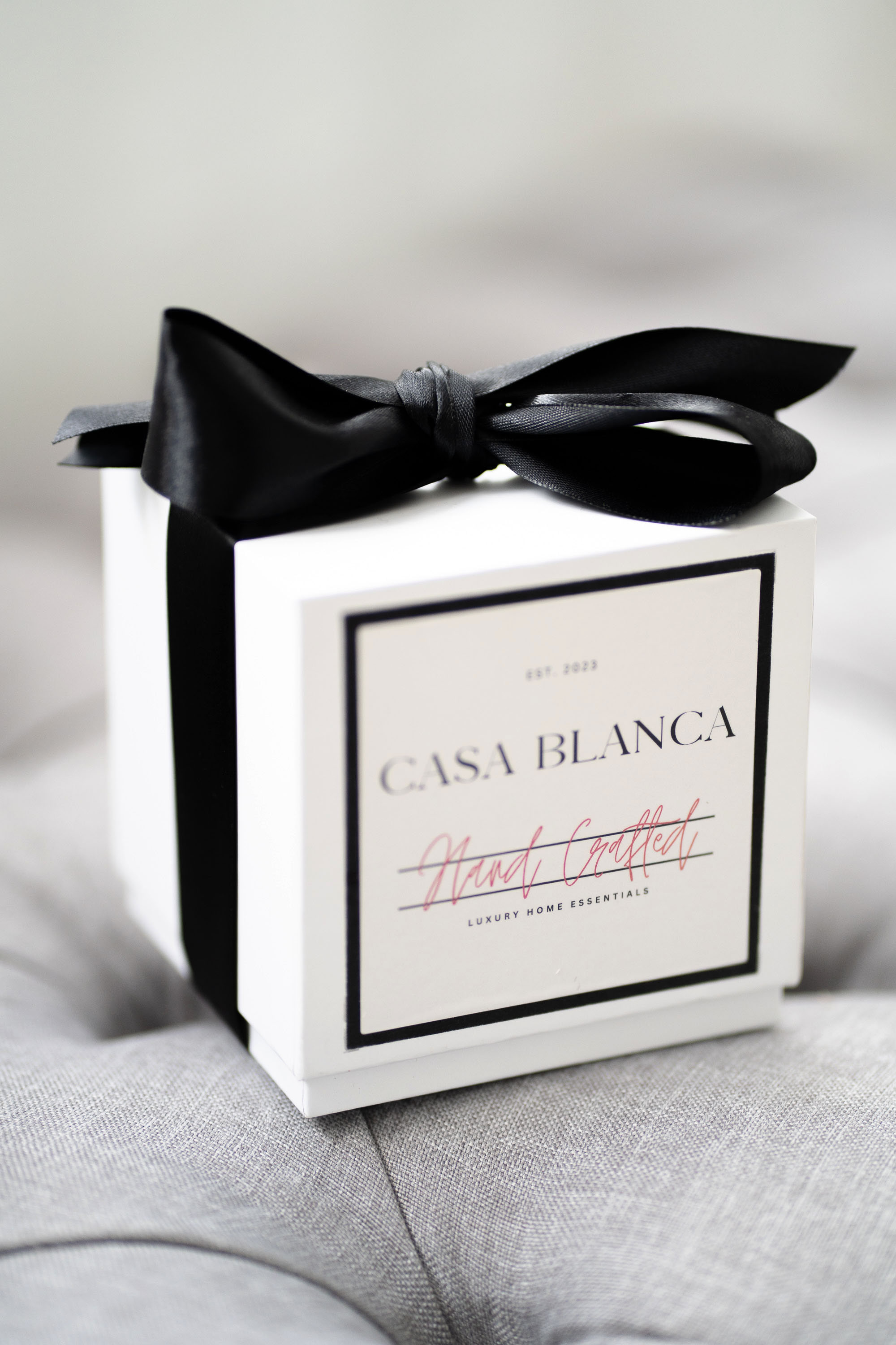 White box with black ribbon bow on top, label reads 'CASA BLANCA' and 'Heart Gift' in red, on a gray surface.