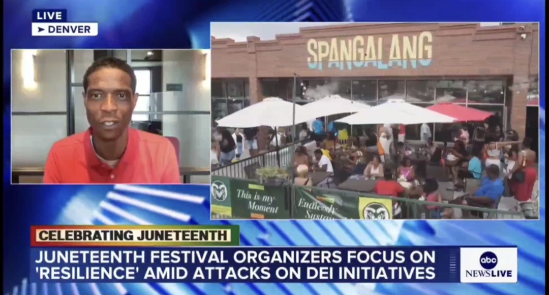 Television news screenshot showing a man in a red shirt and a crowd outside a restaurant with umbrellas, celebrating Juneteenth.