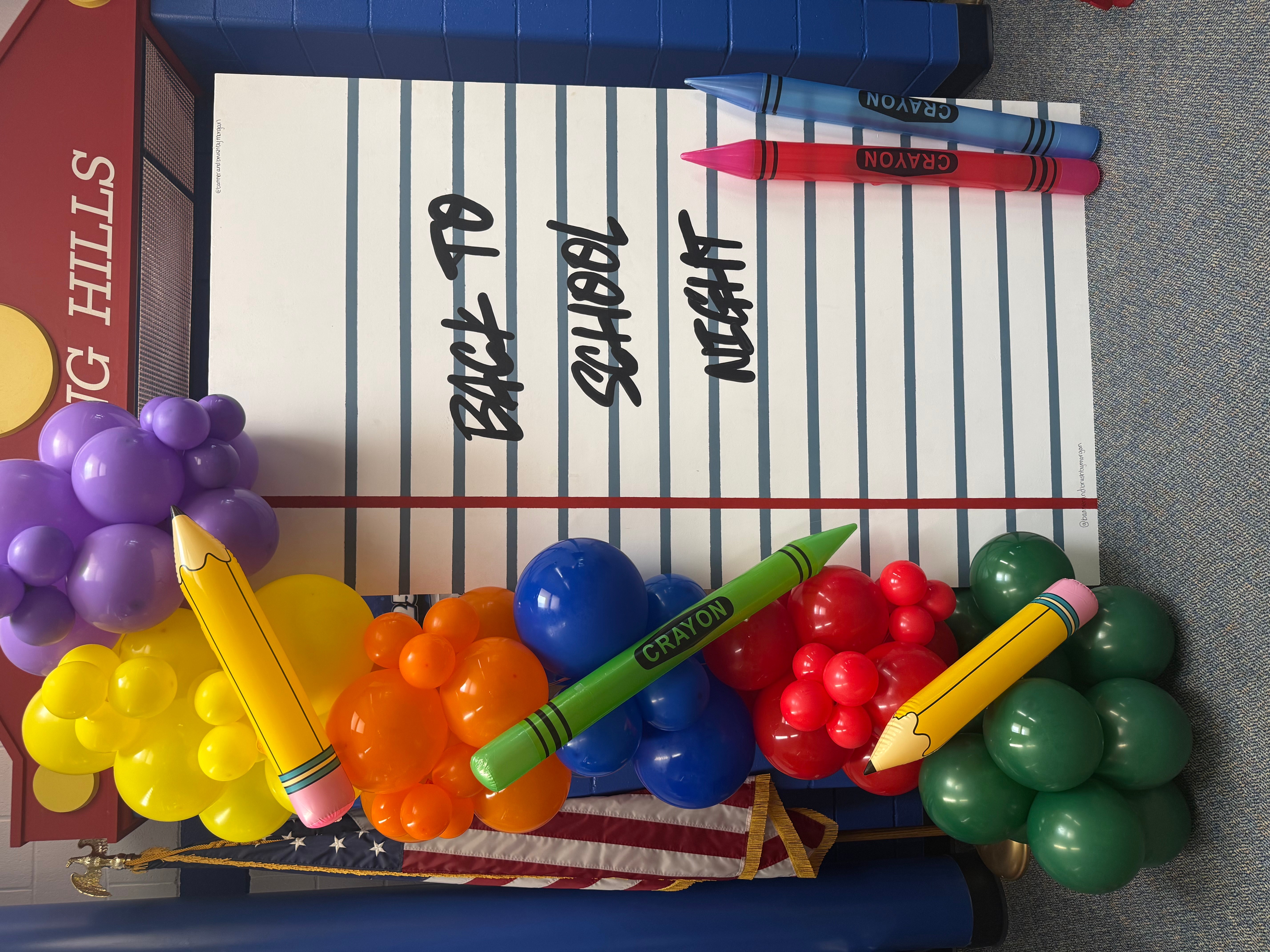 Colorful cluster of pens, markers, and plastic grapes on lined paper with handwritten notes.