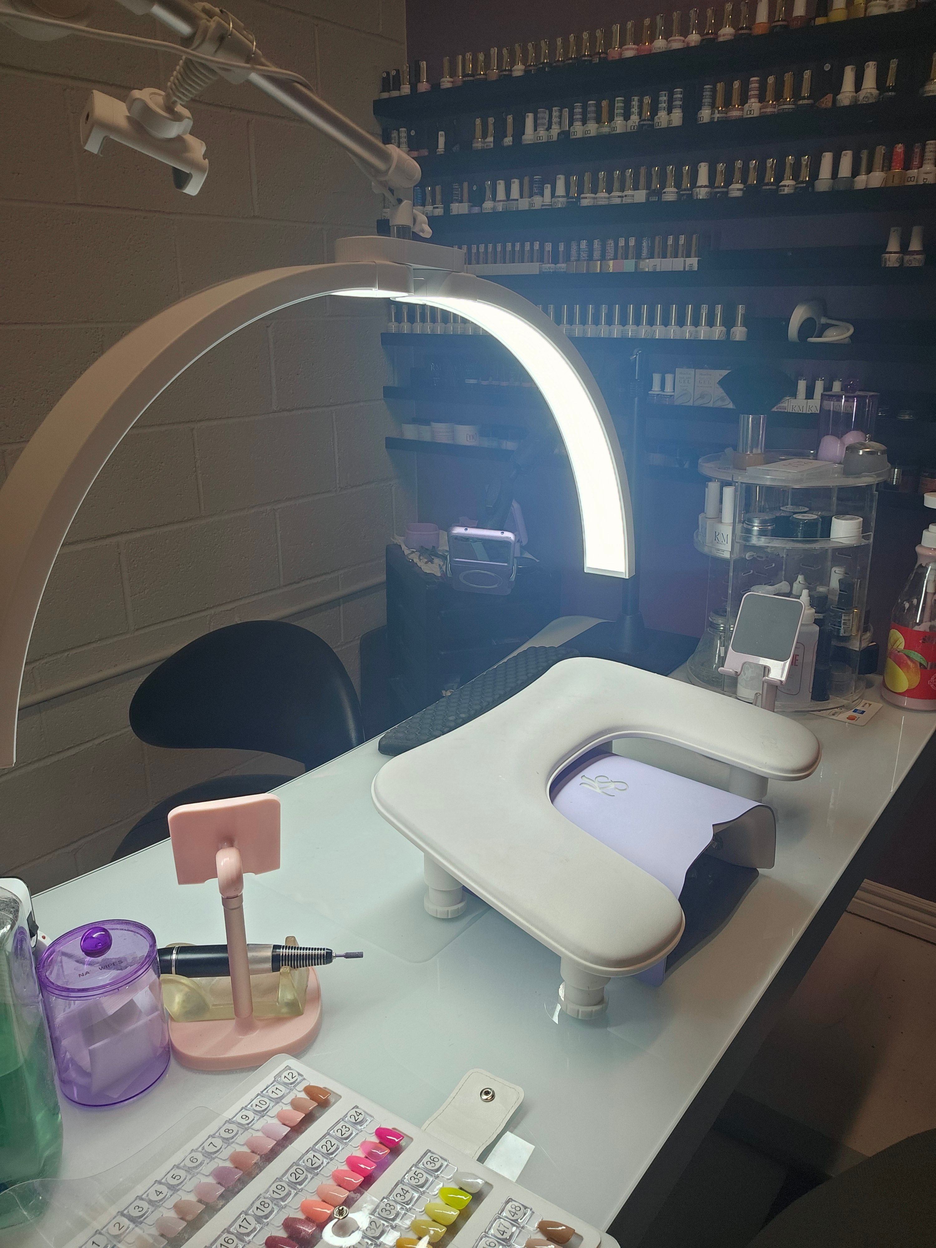 Bathroom countertop with toothbrush, toothpaste, and a purple cup, mirror, and shelves in the background.