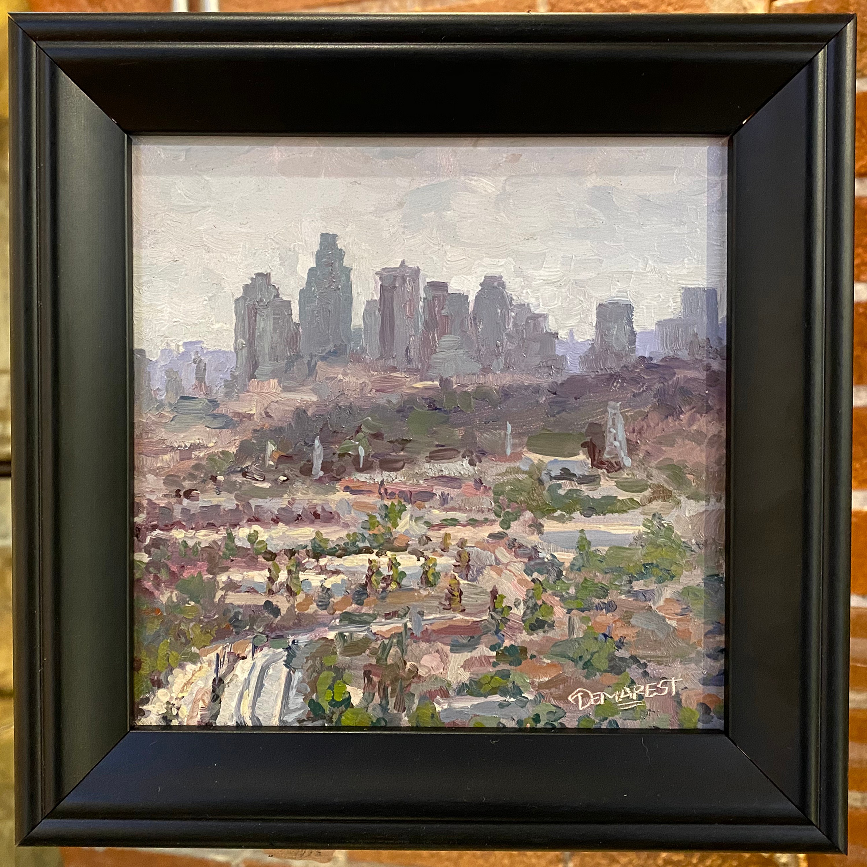Cityscape with tall buildings, painted in an impressionistic style, signed by the artist in the bottom right corner.