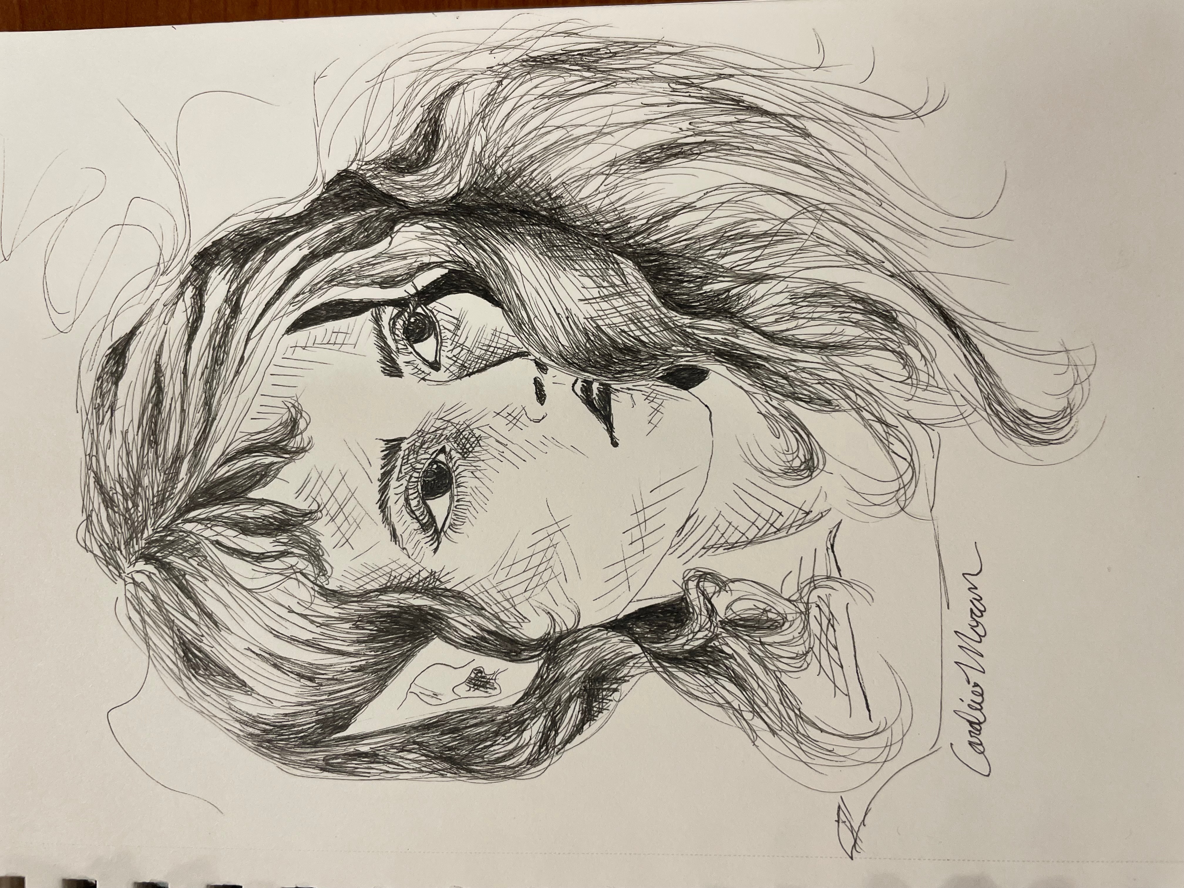 Sketch of a woman's face with long hair, detailed eyes, nose, and lips, and a signature at the bottom right.