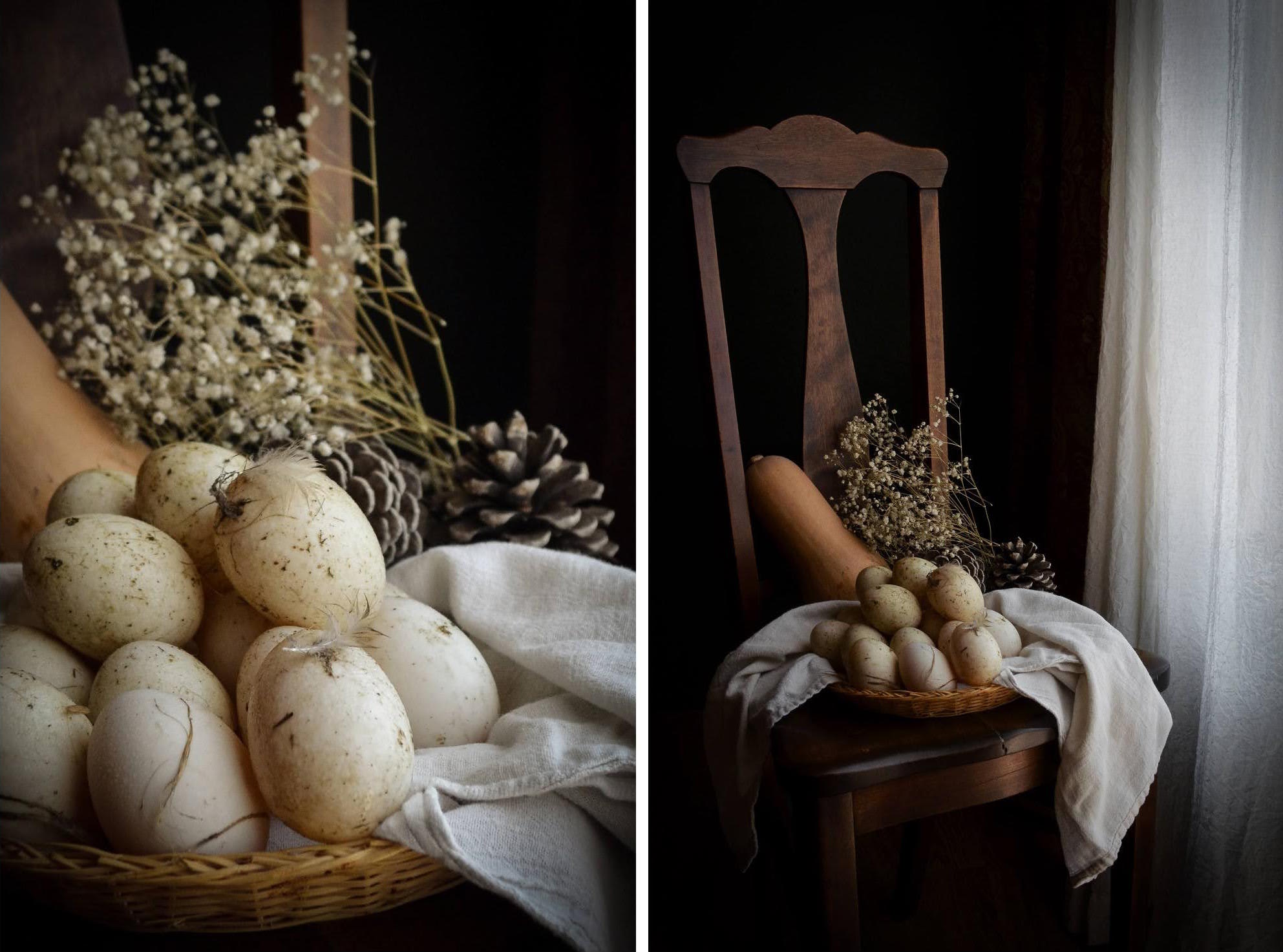 Eggs in a basket with flowers and pinecones, and a chair with eggs and flowers near a window, soft lighting.
