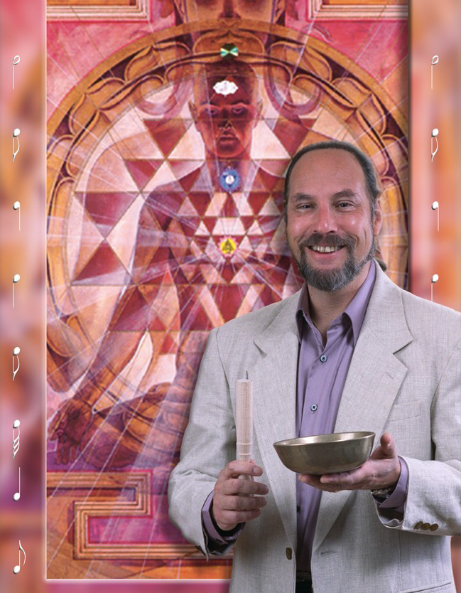 Man in a light gray suit holding a bowl and a stick, standing in front of a colorful geometric background.